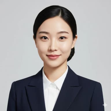 A professional headshot of a young woman for an airline cabin crew application. She is facing the camera with a warm, genuine, closed-lip smile, eyes clear and confident. Hair is neatly tied in a low, polished bun with no flyaways. Makeup is minimal and natural (light foundation, subtle eyeliner, matte pink lipstick). She is wearing a crisp, white, collared blouse with a dark blazer. Background is a plain, solid light gray. Studio lighting, sharp focus, 300 DPI, passport photo dimensions.
